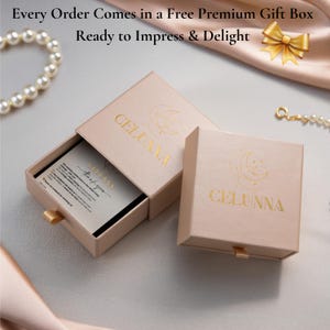 May include: Two open pink gift boxes with gold lettering that reads "CELUNNA". One box is open, revealing a card that says "thank you". The text "Every Order Comes in a Free Premium Gift Box Ready to Impress & Delight" is at the top.