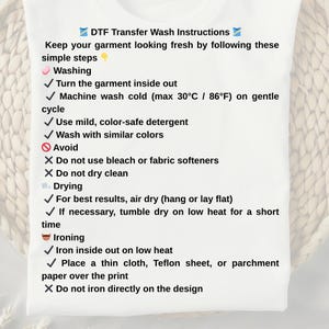 May include: White t-shirt with DTF Transfer Wash Instructions. The text provides care instructions for washing, drying, and ironing. Includes steps for washing, drying, and ironing, with do's and don'ts for garment care.