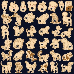 May include: A collection of tan-colored, cartoon-style animal and food-shaped stickers. The stickers include a raccoon, rabbit, hippo, elephant, otter, dog, beaver, donkey, duck, hedgehog, pig, goat, penguin, capybara, squirrel, orca, cat, dog, panda, chicken, shark, and more.