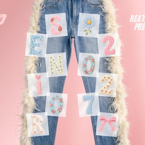May include: Light blue denim jeans featuring white feather trim along the outer seams. The jeans are decorated with various patches including letters spelling SENIOR, the numbers 2027, a blue flower, and a pink bow. Text reads READY TO PRESS.