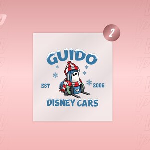 May include: A graphic print featuring the character Guido from Disney Cars wearing a red and white striped winter hat and scarf. The design includes the text GUIDO, EST 2006, and DISNEY CARS in blue, accented with light blue snowflakes.