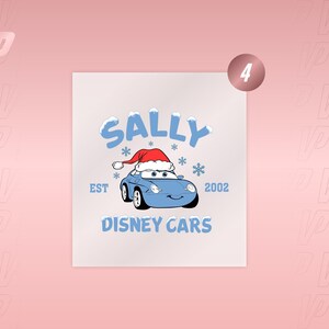 May include: A graphic print featuring a light blue car character wearing a red and white Santa hat, surrounded by blue snowflakes. The text reads SALLY, EST 2002, and DISNEY CARS in light blue lettering against a plain white background.