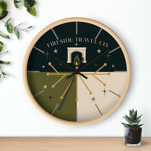 May include: A round wall clock with a light wood frame. The clock face is divided into four sections of dark green, olive green, and beige. The clock features the text "Fireside Travel Co." and a fireplace graphic.