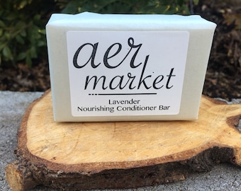 May include: A white bar of lavender-scented conditioner with the text "aer market" and "Lavender Nourishing Conditioner Bar" on the label.