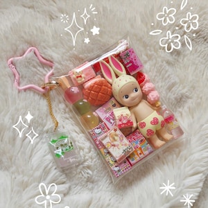 May include: A set of three ceramic mugs with a speckled, matte finish in cream, light grey, and dark grey. Each mug has a simple, minimalist design and a rounded handle. Ideal for tea or coffee.