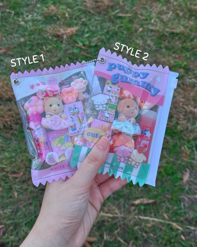 May include: Two clear plastic bags filled with assorted pink and white candies, small toys, and treats. One bag is labeled "STYLE 1" and the other "STYLE 2". The "STYLE 2" bag has the text "puppy gummy" on it.