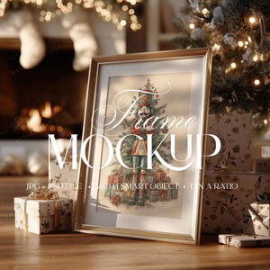 May include: A gold framed print featuring a nutcracker soldier in front of a Christmas tree and presents. The frame is propped up on a wooden surface with wrapped gifts and a Christmas tree in the background. The text "Frame Mockup" is displayed.