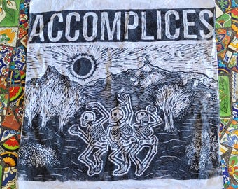 Handprinted woodcut block print bandana titled "Accomplices."