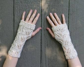 May include: A pair of white crocheted fingerless gloves with a lacy pattern.