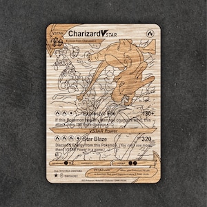 May include: Wooden Charizard VSTAR trading card with engraved details. The card features the text "Charizard VSTAR" and "Explosive Fire". The artwork depicts Charizard in action. A unique collectible for Pokémon fans.