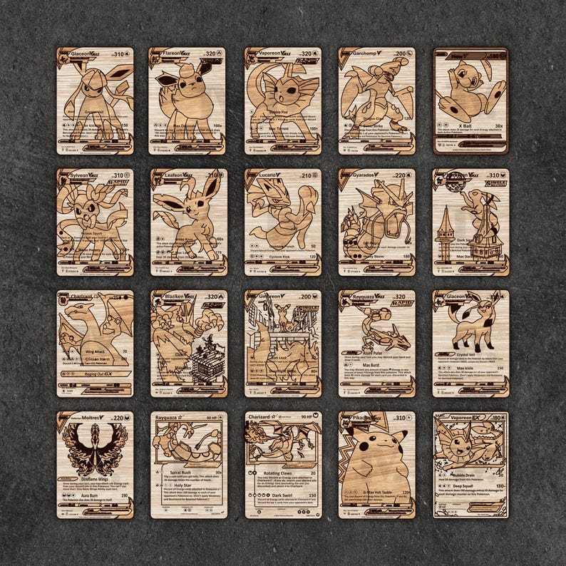 May include: A selection of wooden Pok&eacute;mon trading cards, each with a unique character design. The cards are laser-cut from wood, displaying detailed illustrations of various Pok&eacute;mon. The cards are arranged on a dark surface.