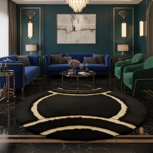 May include: A luxurious living room featuring a black round rug with gold accents, blue sofas, and green armchairs. The room has a dark teal wall color, gold trim, and a chandelier. A painting hangs above the sofa.