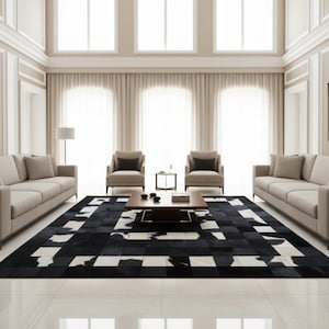 May include: A contemporary living room with a black and white cowhide rug, two beige sofas, two armchairs, and a wooden coffee table. The room has large windows with sheer curtains and a neutral colour palette.