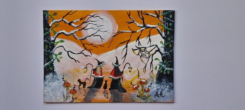 May include: Acrylic painting of a Halloween scene with two witches, black cats, and mushrooms. The witches wear black hats and cloaks, and carry lanterns. The background features a full moon and bare trees.
