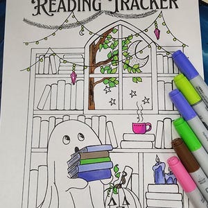 May include: A black and white line drawing of a "Reading Tracker" with a ghost holding books, a pumpkin, and a bookshelf. The drawing includes a window with a tree, moon, and stars. Colored markers are on the right.