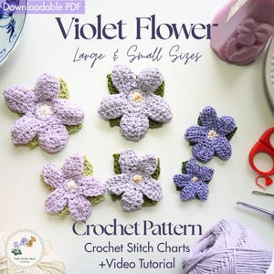 May include: Crocheted violet flower pattern in large and small sizes. The flowers are in shades of purple with green leaves. The image includes crochet hooks, scissors, and yarn. Text on the image reads "Violet Flower" and "Crochet Pattern".
