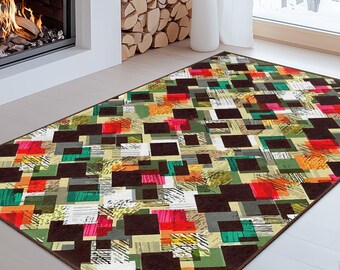 May include: A rectangular area rug with a geometric pattern of squares in various colors, including green, red, black, and white. The rug is placed on a light-colored wooden floor in front of a fireplace.