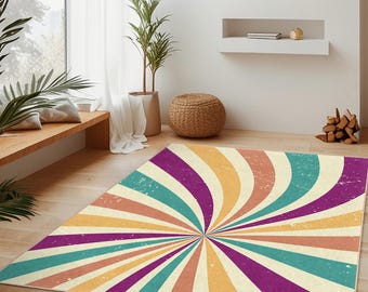 May include: A colorful area rug with a retro spiral design. The rug features a pattern of radiating stripes in shades of purple, teal, orange, and yellow. The rug is rectangular and placed on a hardwood floor in a living room setting.