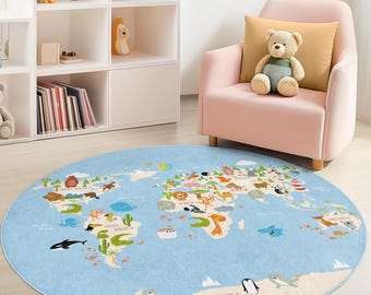 May include: A round, light blue rug with a world map design. The map features continents, oceans, and illustrations of animals and landmarks. The rug has a beige border and is placed on a wooden floor. A pink armchair and a white bookshelf are in the background.