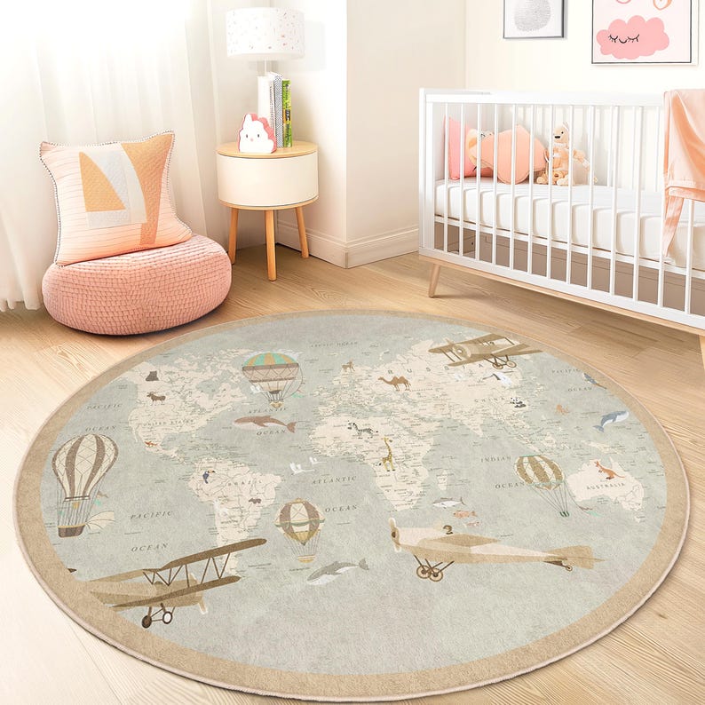 May include: A round, light blue rug with a world map design. The rug features illustrations of hot air balloons, airplanes, and animals. The rug has a beige border and is placed on a wooden floor.