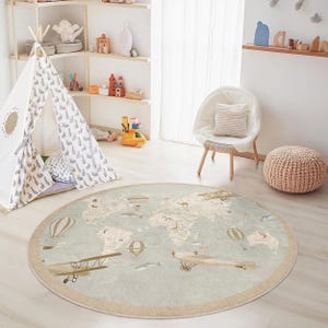 May include: A round area rug with a world map design, featuring illustrations of airplanes, hot air balloons, and animals. The rug has a light blue background with a beige border, suitable for a child's room.