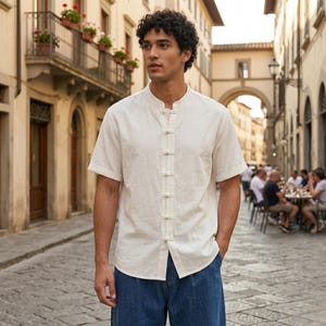 White short sleeve Tencel summer shirt with mandarin collar and frog button front for casual festival wear.
