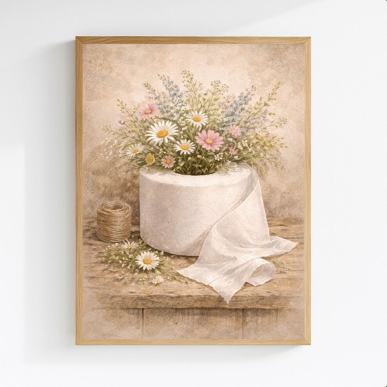 Puede incluir: Impresi&oacute;n enmarcada que representa un rollo de papel higi&eacute;nico blanco con un ramo de margaritas, flores rosas y flores silvestres azules. Una peque&ntilde;a bobina de hilo se encuentra junto al papel higi&eacute;nico sobre una superficie de madera. La obra tiene una est&eacute;tica vintage.