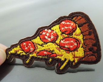 May include: Embroidered iron-on patch of a pizza slice with red pepperoni and a yellow crust.