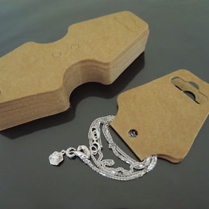 100pcs Fold Over Kraft Hang Tag pour collier, bracelet, queue de cheval, bande de cheveux, élastique, affichage de bijoux et fournitures