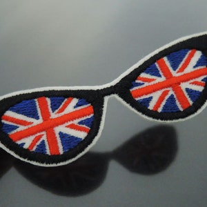 May include: Embroidered iron-on patch of a pair of sunglasses with the Union Jack flag design in the lenses.
