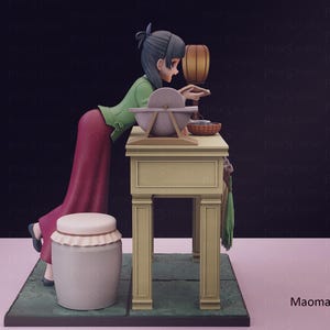May include: A 3D-rendered figurine of a woman in traditional attire, leaning over a table with a grinding stone. The figure wears a green top and a long red skirt. A white jar with a lid is in the foreground.