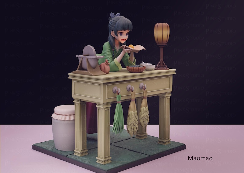 May include: A detailed figurine of a woman in a green outfit, working at a table. The table has a lamp, bowls, and a grinding stone. Decorative brooms hang below. The base is green, and the background is dark.