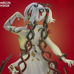 May include: A white figurine with a flowing dress and long, curly black and red vines. The figurine has white hair with red accents and is adorned with red roses. The text "CAMELLYA JAN2025" is in the upper left corner.