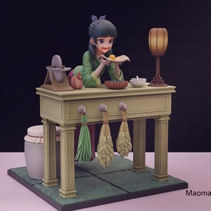 May include: A detailed figurine of a woman in a green outfit, preparing food at a table. The table has a lamp, a bowl, and a basket. Decorative bundles hang below the table. The base is green with a tile pattern.