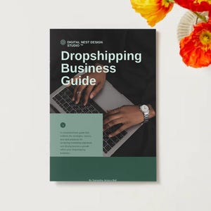 May include: A book cover titled "Dropshipping Business Guide" with the Digital Nest Design Studio logo. The cover features a person's hands on a laptop keyboard, a watch, and a green and black colour scheme. The book is on a white surface with flowers.
