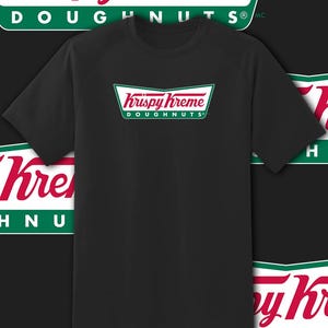 May include: Black short-sleeve t-shirt featuring the Krispy Kreme logo in red and white with green accents. The logo is centered on the chest. The words "Krispy Kreme Doughnuts" are printed on the shirt.