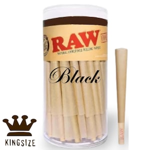 May include: A clear plastic tube containing several pre-rolled cones. The tube has a brown label with the word "RAW" in red letters. The word "Black" is written in cursive on the tube. A single cone is displayed next to the tube. The bottom of the tube has the words "KINGSIZE" and a crown.
