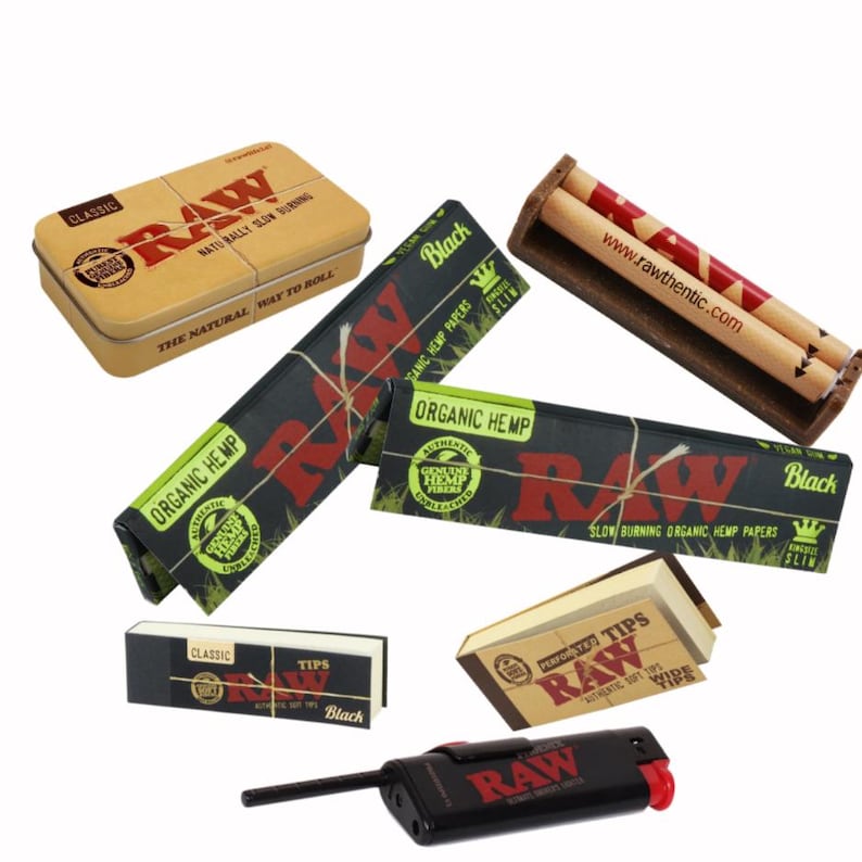 May include: An assortment of RAW brand smoking accessories, including rolling papers, tips, a rolling machine, a lighter, and a tin. The products feature the RAW logo in red on a variety of packaging.