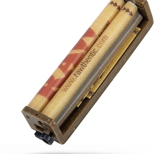 May include: A brown rolling machine with two cylindrical rollers. One roller has a red and white design, the other has the text "www.rawthentic.com". The machine has a black knob and is designed for rolling.
