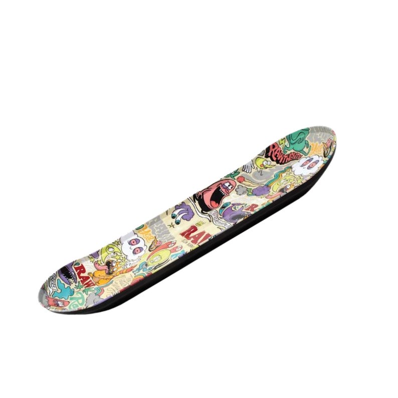May include: A skateboard with a black underside and a colorful graphic design featuring cartoon characters and the word "RAW". The deck has a variety of colors, including red, green, yellow, and purple.