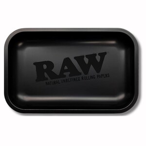 May include: A black rectangular rolling tray with rounded corners. The tray features the word "RAW" in large, bold letters, with "NATURAL UNREFINED ROLLING PAPERS" printed below. The tray is made of a solid, matte black material.