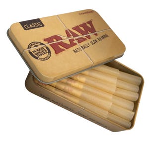 May include: A tan metal tin with the word "RAW" in red lettering and the text "NATURALLY SLOW BURNING". The tin is open, revealing several pre-rolled cones. The tin also has the text "CLASSIC" and "AUTHENTIC PUREST GENUINE FIBERS UNBLEACHED".