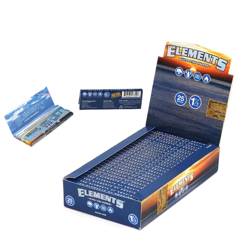 May include: A display box of Elements ultra-thin rolling papers. The box is blue with a sunset design and the brand name. A pack of papers is open, showing the contents. The box indicates 25 papers per box and 1 1/4 size.