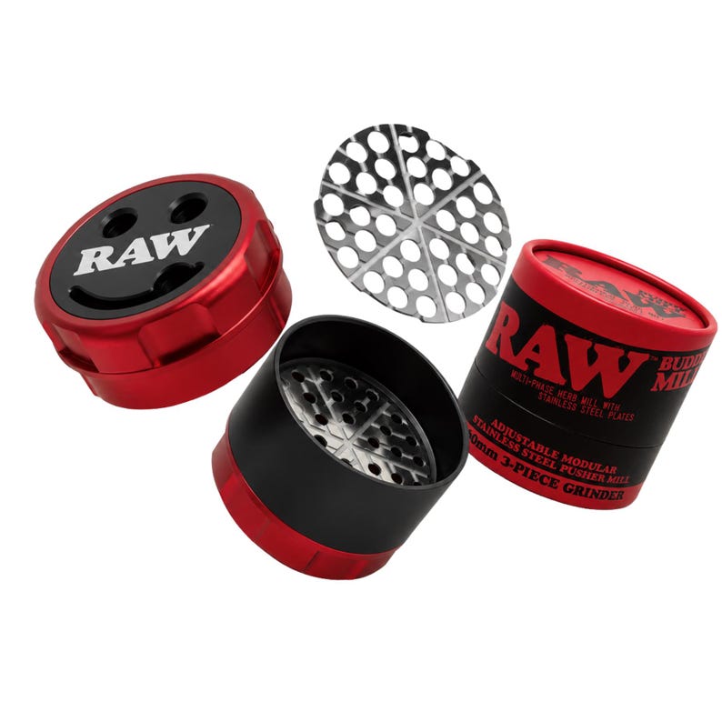 May include: A red and black 3-piece grinder with the word "RAW" on the top. The grinder is modular and adjustable, with stainless steel plates. The image also shows a stainless steel pusher and a round metal screen.
