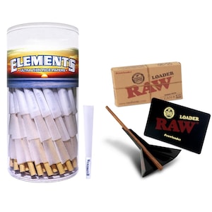 May include: A collection of smoking accessories, including a clear plastic container of pre-rolled cones, a single cone, a cardboard box, a black card, and a wooden and black loading device. The container has the text "ELEMENTS ULTRA THIN RICE PAPERS."