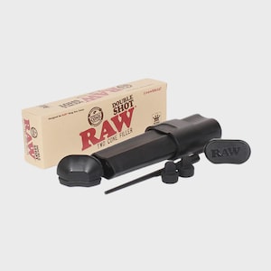 May include: A black RAW Double Shot two cone filler kit with a box. The kit includes a filling tool, two cone holders, a packing tool, and a lid. The box is tan with red and black text and graphics.