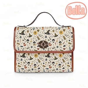 May include: A cream-colored handbag with a brown handle and trim. The bag features a repeating pattern of wizard-themed illustrations, including hats, lightning bolts, and books. The bag has a metal clasp and the word "Bella" in a pink circle.