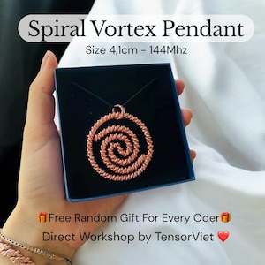 May include: A copper-colored spiral vortex pendant on a black cord, displayed in a blue box. The pendant is approximately 4.1 cm in size. The text "Spiral Vortex Pendant" and "Size 4,1cm - 144Mhz" are visible.