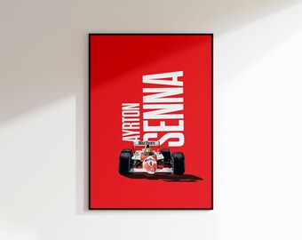 May include: A framed poster featuring a Formula 1 race car against a vibrant red background. The poster prominently displays the name "AYRTON SENNA" in large white letters. The car is red and white with black tires.