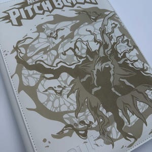 May include: A white card binder featuring a gold graphic of a tree-like creature with swirling branches and the text MEGA EVOLUTION PITCH BLACK at the top. The brand name vaultx is embossed in white at the bottom of the textured cover surface.
